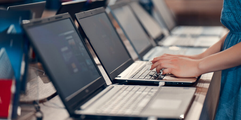 A,Young,Girl,Is,Testing,A,Laptop,In,An,Electronics